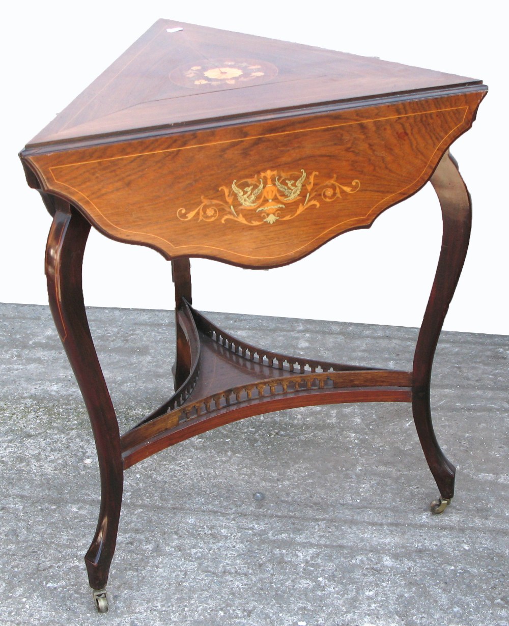 An Edwardian inlaid drop leaf corner table, lower shelf with gallery sides on cabriole legs and