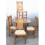 A pale oak drop leaf dining table on barley twist supports and four dining chairs with bergère