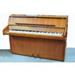 A 20th century upright piano by Bentley, length 139cm.