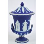 A 19th century Wedgwood blue jasperware campana form lidded urn decorated in relief with classical