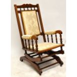 A late 19th century American rocking chair with padded back and seat.