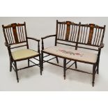 An Edwardian mahogany satinwood inlaid three piece parlour suite comprising two seater settee and a
