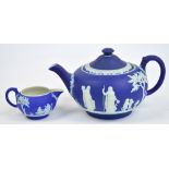 An early 20th century Wedgwood blue jasperware teapot decorated in relief with classical figures,