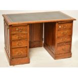 A mid 20th century oak pedestal desk of plain design with three shallow drawers and one deep drawer