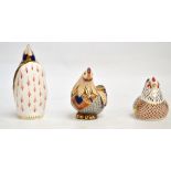 Two Royal Crown Derby paperweights; hen with gold stopper and a penguin (stopper missing),