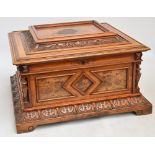 A Victorian walnut polyphon, the rectangular case with hinged lid carved with foliate scrolls and