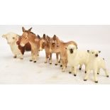 Seven Beswick figures; three donkeys and a donkey foal, a sheep and a lamb, also a matt glazed