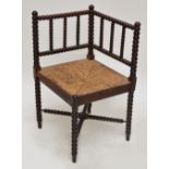 A c.1900 oak bobbin turned corner chair with rush seat.