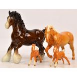 Four Beswick figures of horses; palomino stocky jogging mare, no.855 (third version), two foals, (