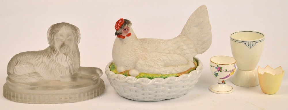 A 19th century hen basket bowl and cover, a glass mould in the form of a seated dog,