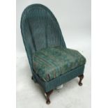 A burgundy button upholstered walnut framed low nursing chair raised on knee carved cabriole front