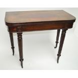 An early 19th century mahogany rounded rectangular tea table raised on fluted tapering legs to