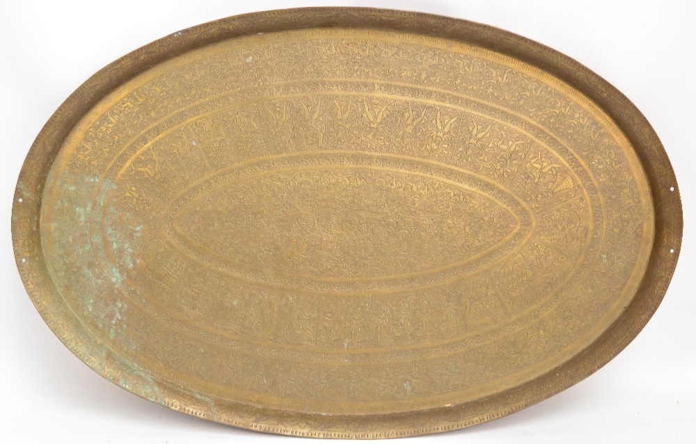 An oval engraved Indian brass tray, length 71.5cm.