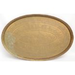 An oval engraved Indian brass tray, length 71.5cm.