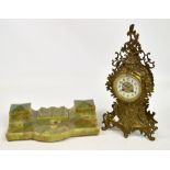 A 20th century French metal mantel clock of pierced scrolling floral and foliate design,