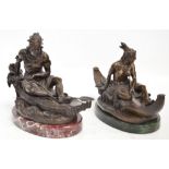 After DUCHOISELLE; a near pair of early 20th century bronze figures of Native Americans in canoes,