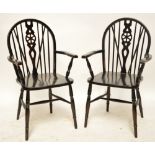 A pair of wheel back elbow chairs with ring turned front legs.