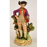 A late 18th century Derby porcelain figure of a man with his dog, incised "N60" to base,