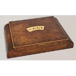 An amboyna veneered games box, the hinged lid set with inlaid cards representing the four suits,