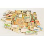 A collection of predominantly loose cigarette cards.