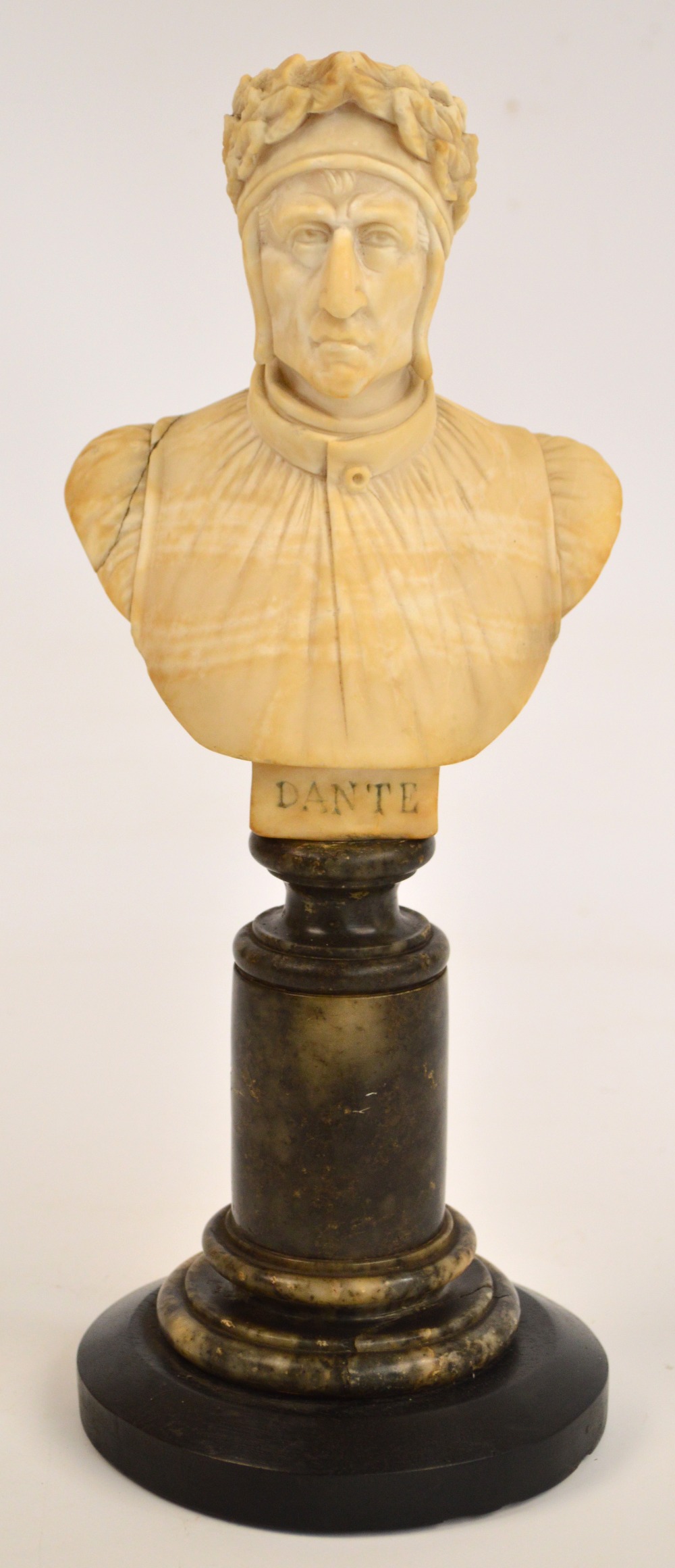 A late 19th century carved alabaster bust "Dante", raised on turned pedestal and wooden plinth,