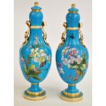 A pair of 19th century Minton porcelain bottle vases and covers, painted with floral sprays on a