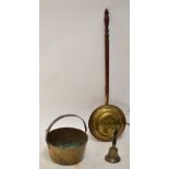A Victorian brass bell with ebonised turned handle, a brass jam pan with fixed loop handles,