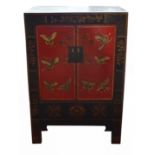 A small Oriental cabinet with gilt decoration on a black lacquer ground,