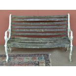 A white painted cast aluminium bench.