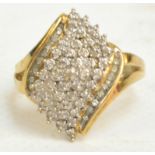 A 9ct yellow gold ring set with forty-four diamond chips in a raised lozenge shape with a line of