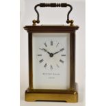 A Swiss brass carriage clock with bevelled glass sides and rectangular enamel dial set with Roman