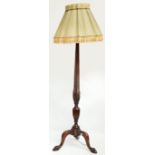A mahogany standard lamp, the tapering fluted column carved with wheat,