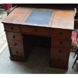 A Victorian mahogany nine drawer pedestal desk with sloping hinged lined writing surface.