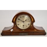 An early 20th century mahogany and inlaid mantel clock, the circular dial set with Arabic numerals,