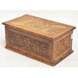 An Edwardian carved oak glove box with hinged lid, width 36cm.