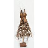 An unusual Native American tree form sculpture adorned with feathers and seed pods, height 148cm.