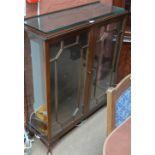 A mahogany two door glazed display cabinet on squat cabriole legs to pad feet.