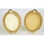 A pair of early 20th century oval carved ivory photograph frames,