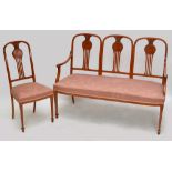 An Edwardian satinwood and inlaid five piece salon suite comprising triple arch back settee and