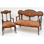 An Edwardian mahogany upholstered parlour settee with shaped back and three pierced splats,