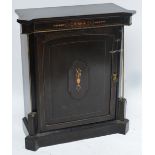 A late 19th century ebonised pier cabinet with shaped top above inlaid frieze,