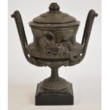 An early 20th century spelter lidded campana form urn, applied with two cherubs,