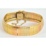 An 18ct two tone textured bracelet, approx 44.7g.