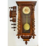 A late 19th century stained beech and walnut cased eight day spring driven Vienna wall clock by