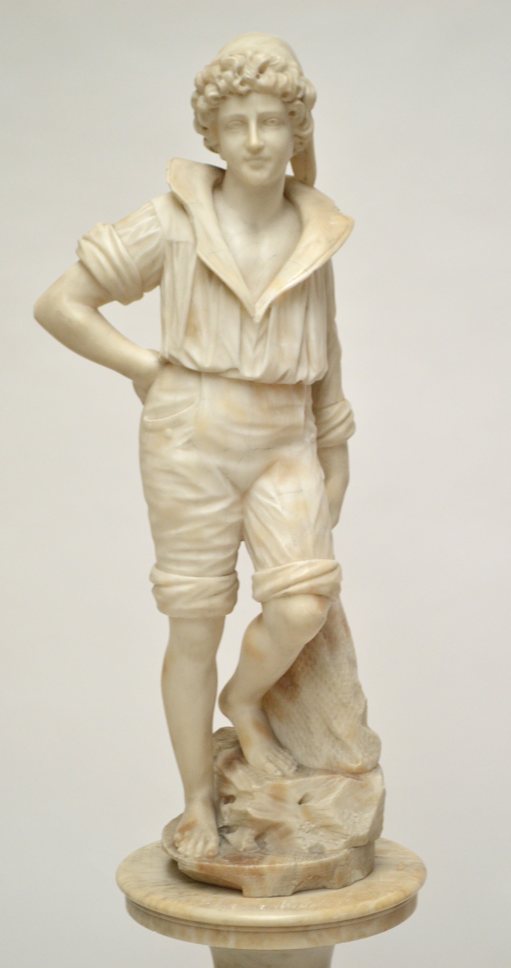 A late 19th/early 20th century carrara alabaster figure of a young fisherman modelled with a net - Image 2 of 15