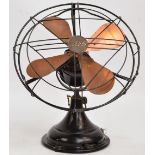 A 1950s GEC electric fan, the front grid centred with company plaque, the body painted in black,