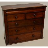 A Victorian mahogany chest with cushion drawer above two short and three long drawers, lacking feet,