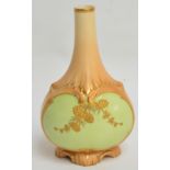 A Locke & Co. blush ivory bottle vase with gilt pine cone decoration on pale green ground, shape