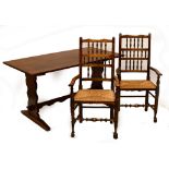 An oak refectory table raised on shaped end supports,