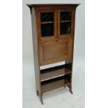 An Arts and Crafts open oak bookcase with chevron inlay.